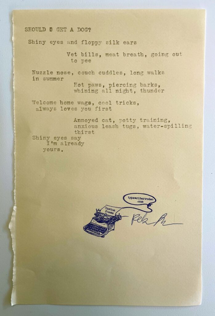 A photo of the typewritten poem on a torn half-sheet of light yellow paper.