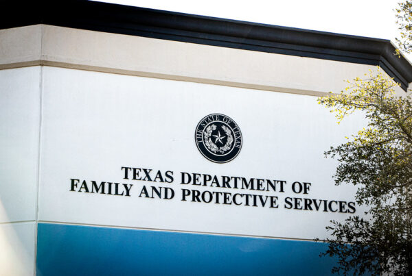 Signage on the exterior of a building reads "Texas Department of Family and Protective Services" below the State of Texas seal