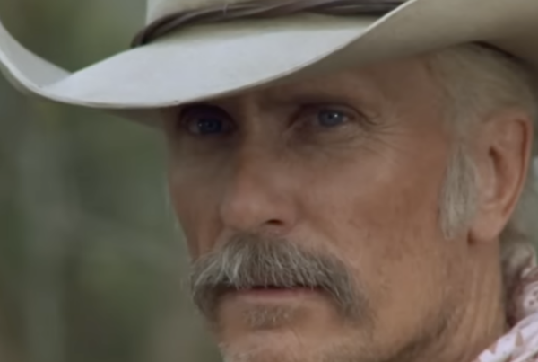 A close-up photo of Robert Duvall wearing a cowboy hat in a scene from Lonesome Dove.