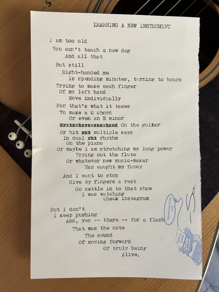 A photo of the typewritten poem on a torn half-sheet of light yellow paper.