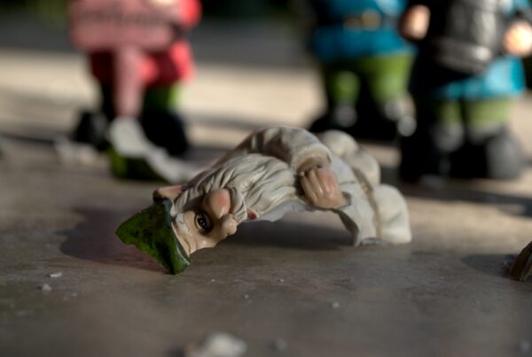 A close up photo of a broken garden gnome.