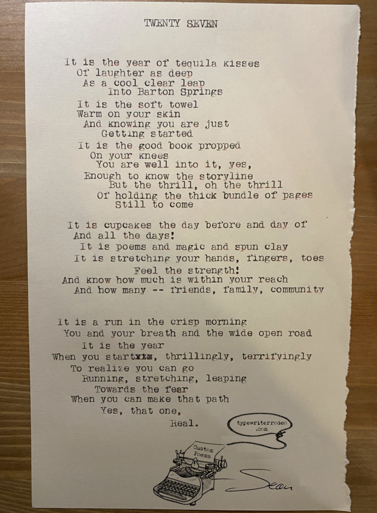 A photo of the typewritten poem on a torn half-sheet of light yellow paper.