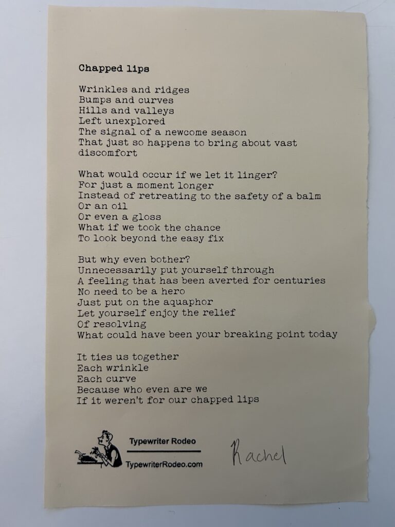A photo of the typewritten poem on a torn half-sheet of light yellow paper.