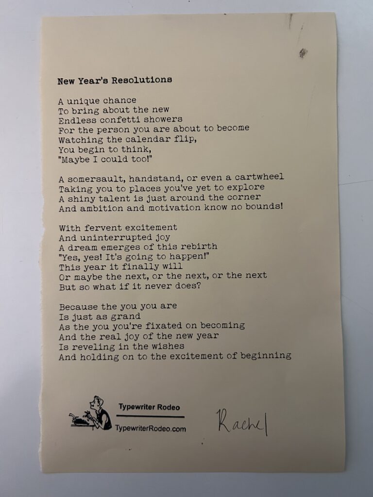 A photo of the typewritten poem on a torn half-sheet of light yellow paper.
