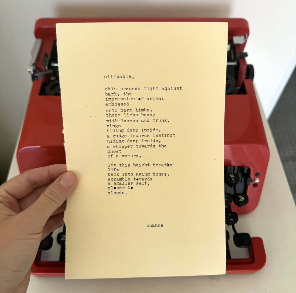 A photo of the typewritten poem on a torn half-sheet of light yellow paper.