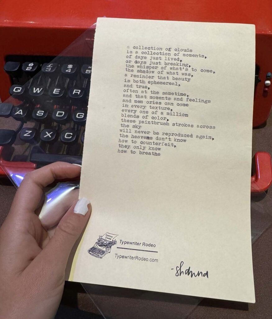 A photo of the typewritten poem on a torn half-sheet of light yellow paper.