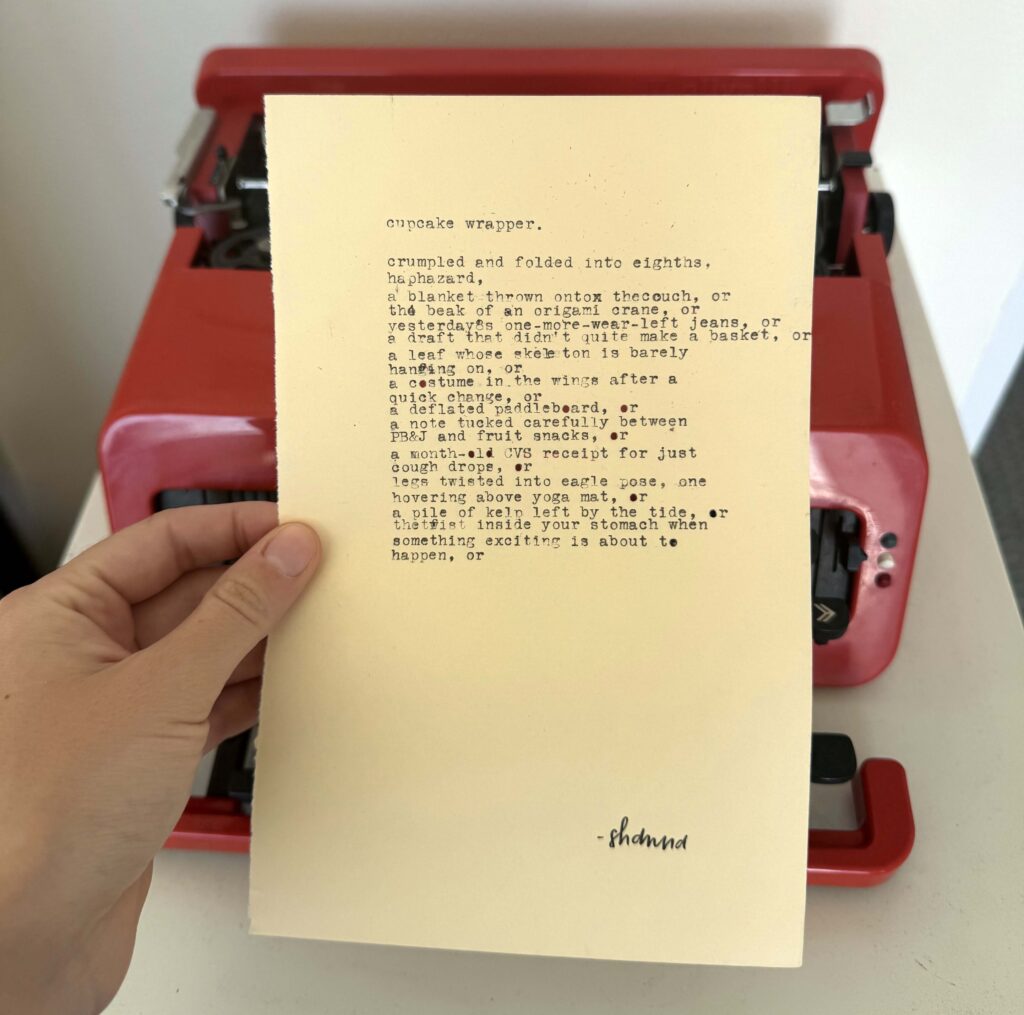 A photo of the typewritten poem on a torn half-sheet of light yellow paper.