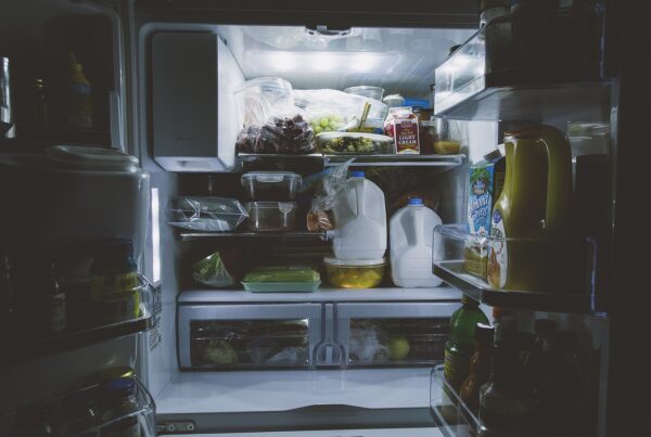 An open refrigerator stuffed with food