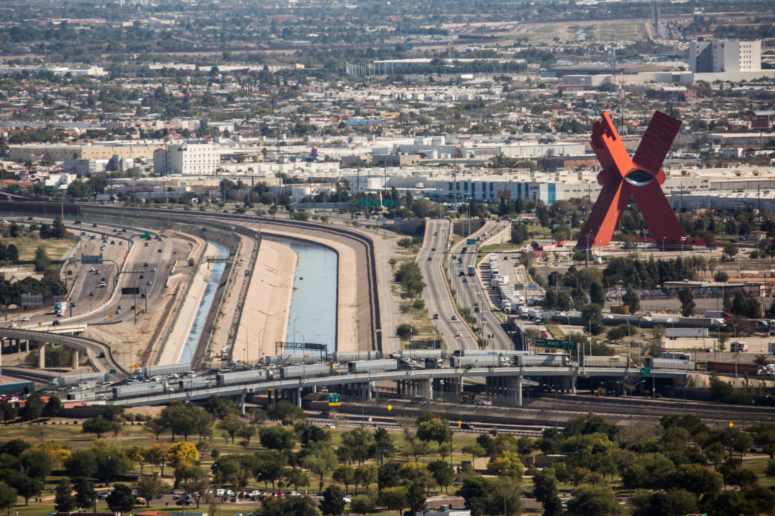 The Bridge of the Americas is seen from a distance with several semi-trailer trucks on it traversing from Ciudad Ju&aacute;rez, Mexico, to El Paso, Texas.
