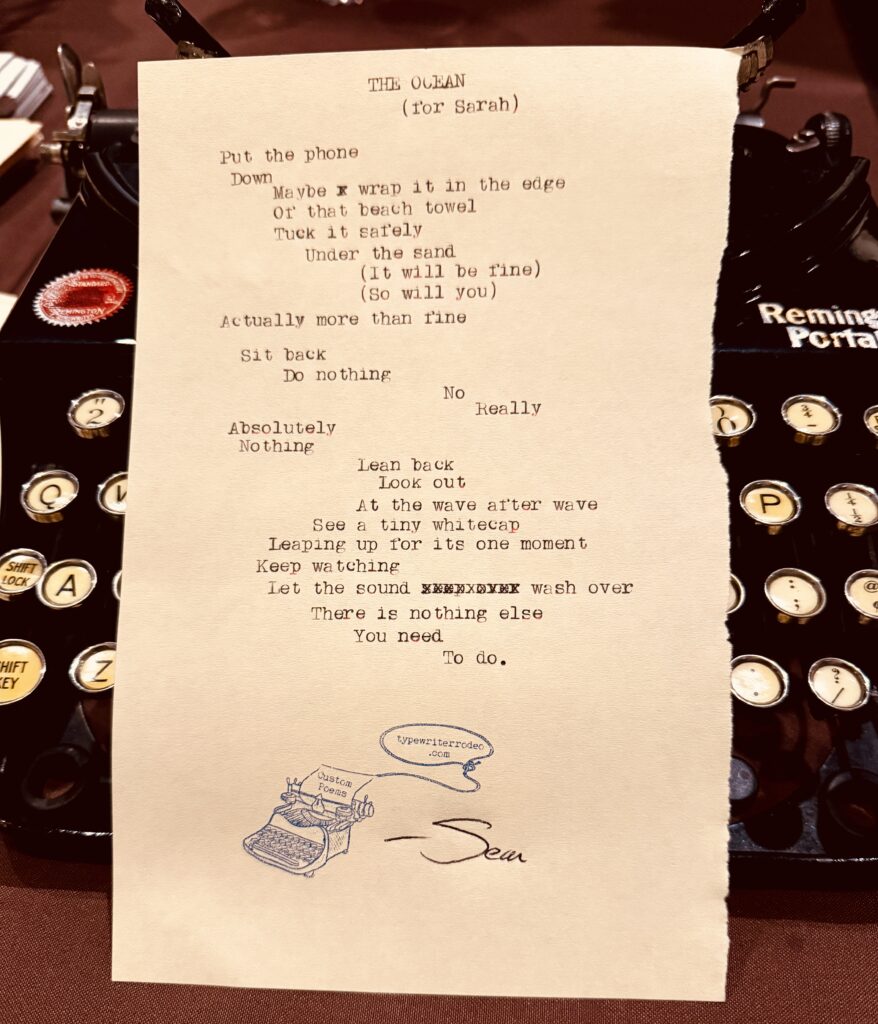 A photo of the typewritten poem on a torn half-sheet of light yellow paper.