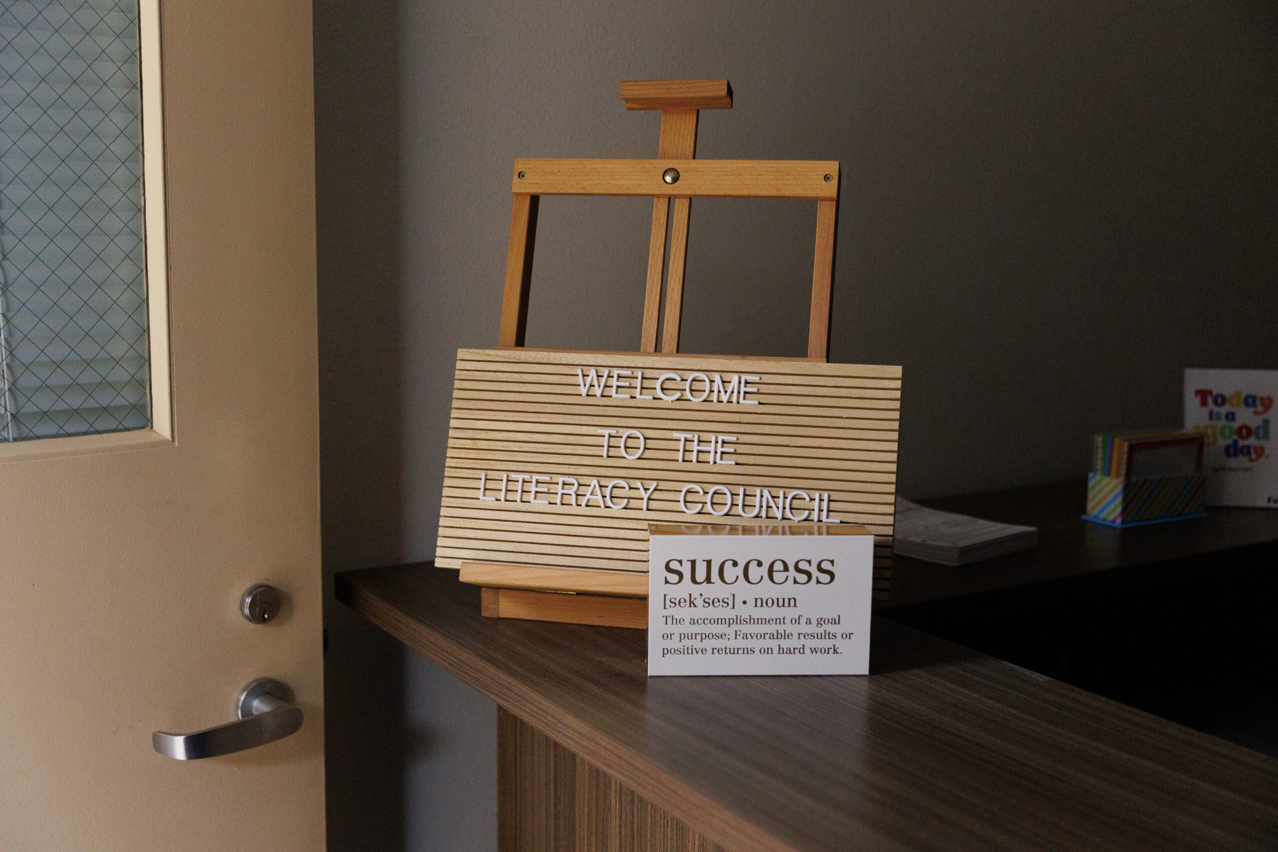 A small sign at a check-in desk reads 