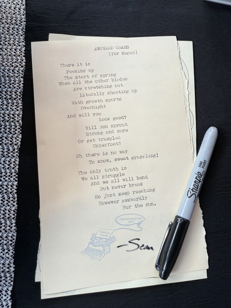 A photo of the typewritten poem on a torn half-sheet of light yellow paper.