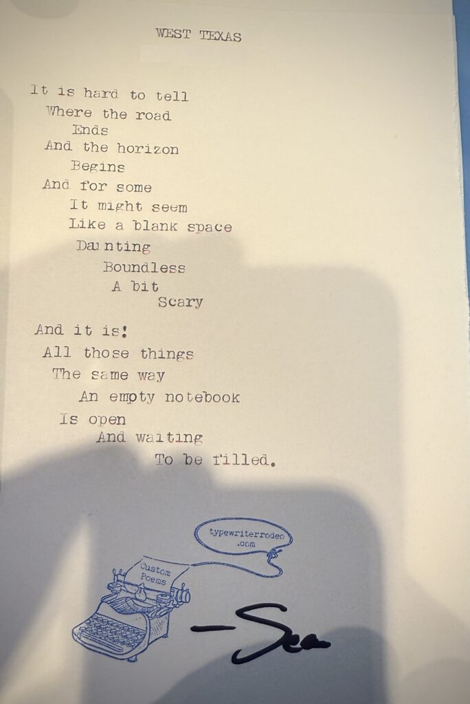 A photo of the typewritten poem on a torn half-sheet of light yellow paper.