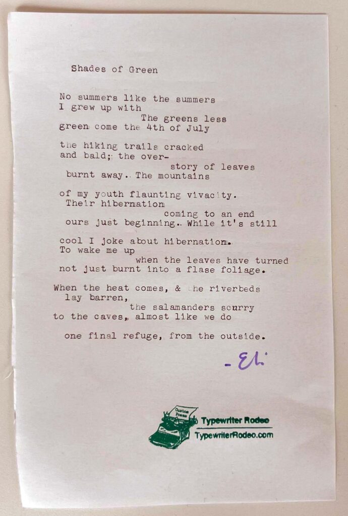 A photo of the typewritten poem on a torn half-sheet of light paper.