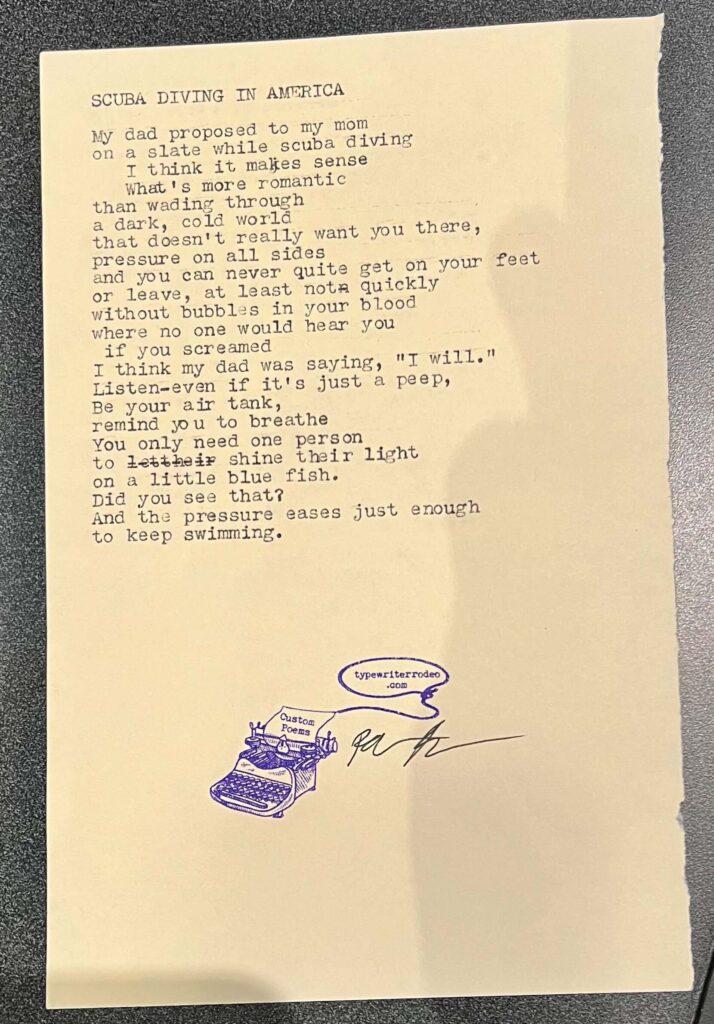 A photo of the typewritten poem on a torn half-sheet of light yellow paper.
