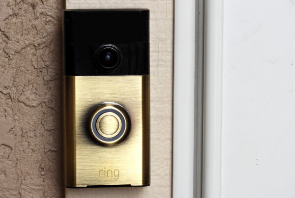 A black and gold Ring doorbell with camera