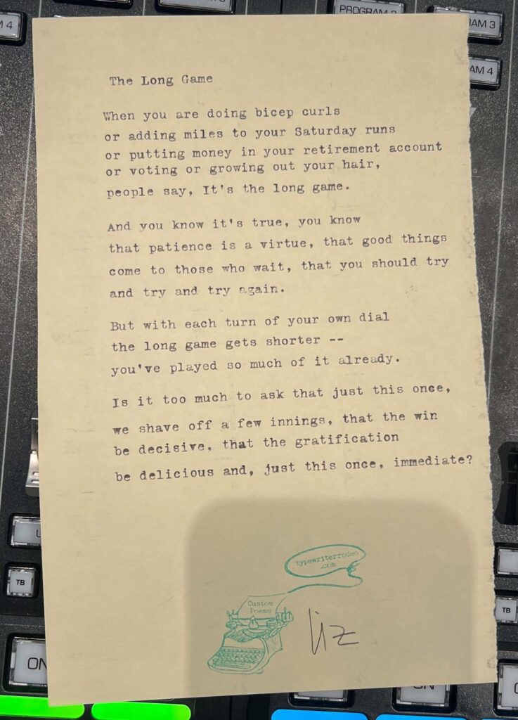 A photo of the typewritten poem on a torn half-sheet of light yellow paper.