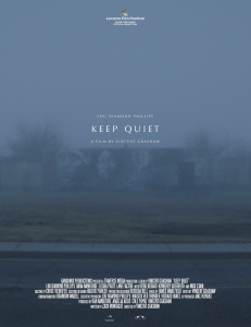 A poster for the film "Keep Quiet" shows a building with a mural of faces on it barely visible behind a blue fog.