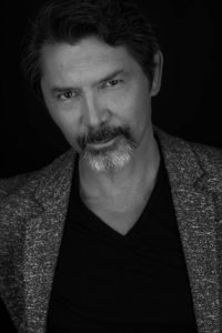 A black and white headshot of Lou Diamond Phillips.