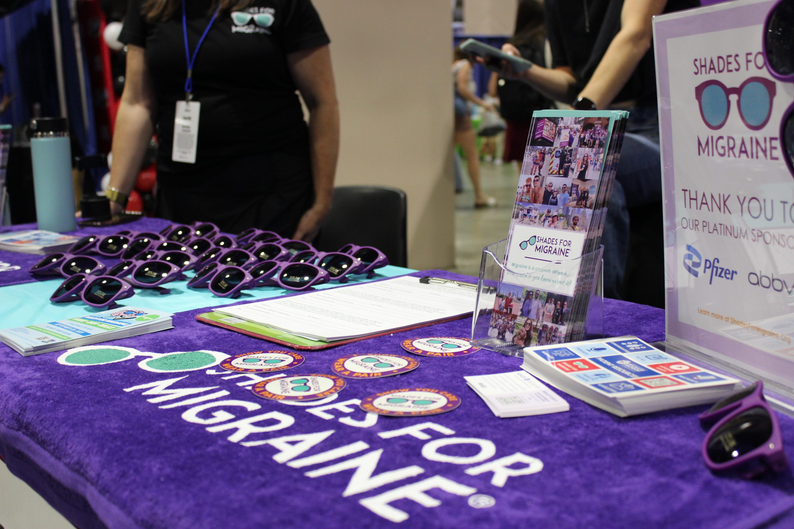 A photo of a table with sunglasses and stickers raising awareness for 