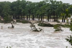 The Guadalupe River in Kerrville floods following heavy overnight rains on Thursday, July 16, 2026. Camps in the area have put their storm response plans in effect.