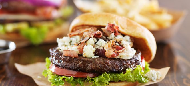 Bacon Blue Cheese Burger with Caramelized Onions – Grill Madness gourmet burgers on wooden table with bleu cheese and bacon