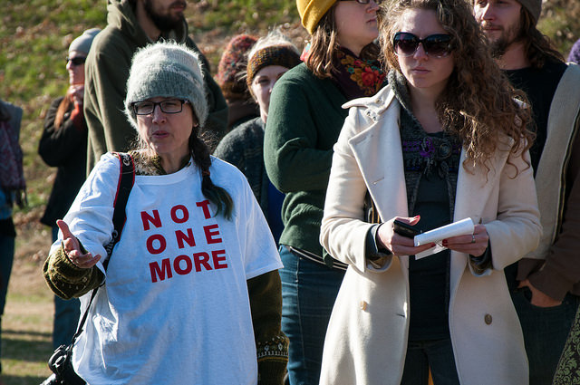 A group of women protest Phi Kappa Psi at the University of Virginia after a Rolling Stone article uncovered an alleged gang rape and other sexual assaults on campus.