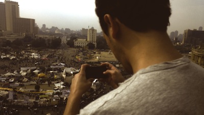 Jonas Vig of Bambuser livestreaming via his mobile phone above Tahrir Square in downtown Cairo days before the November 2011 elections.