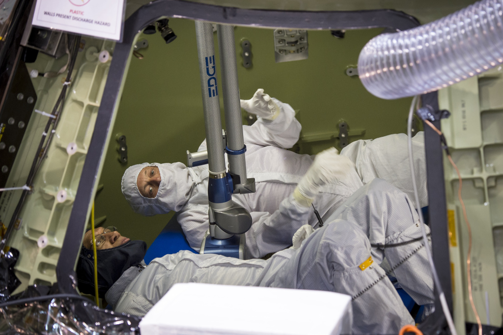 NASA Administrator Charles Bolden, foreground, and Scott McDade of Lockheed Martin inspect the Orion Multipurpose Crew Vehicle in November 2013 before its first test flight.