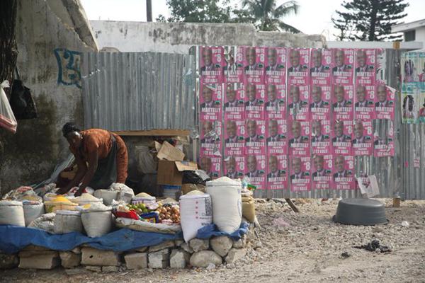 A photo from Kojo's trip to Port-au-Prince in November 2010. Campaign signs for the president, who five years later is delaying elections, are seen in the background. 