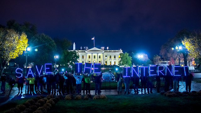 Protestors supporting Net Neutrality stand in front of the White House. 