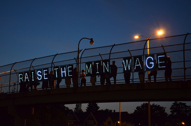 Wisconsin activists for raising the minimum wage display their message on an overpass.