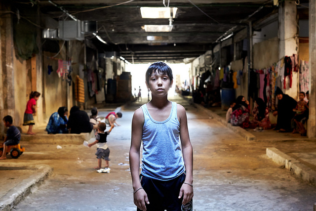 Syrian refugee Mahmoud, in the underground shelter where he lives with his family in El Akbiya, Lebanon in 2013.