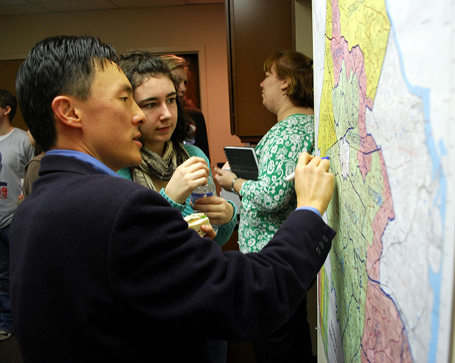 Then-candidate Mark Keam draws his district on a map at his campaign kickoff event in Vienna, Va.