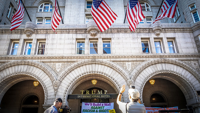 Protesters denounce Donald Trump outside the Trump International Hotel on the day of its soft opening.