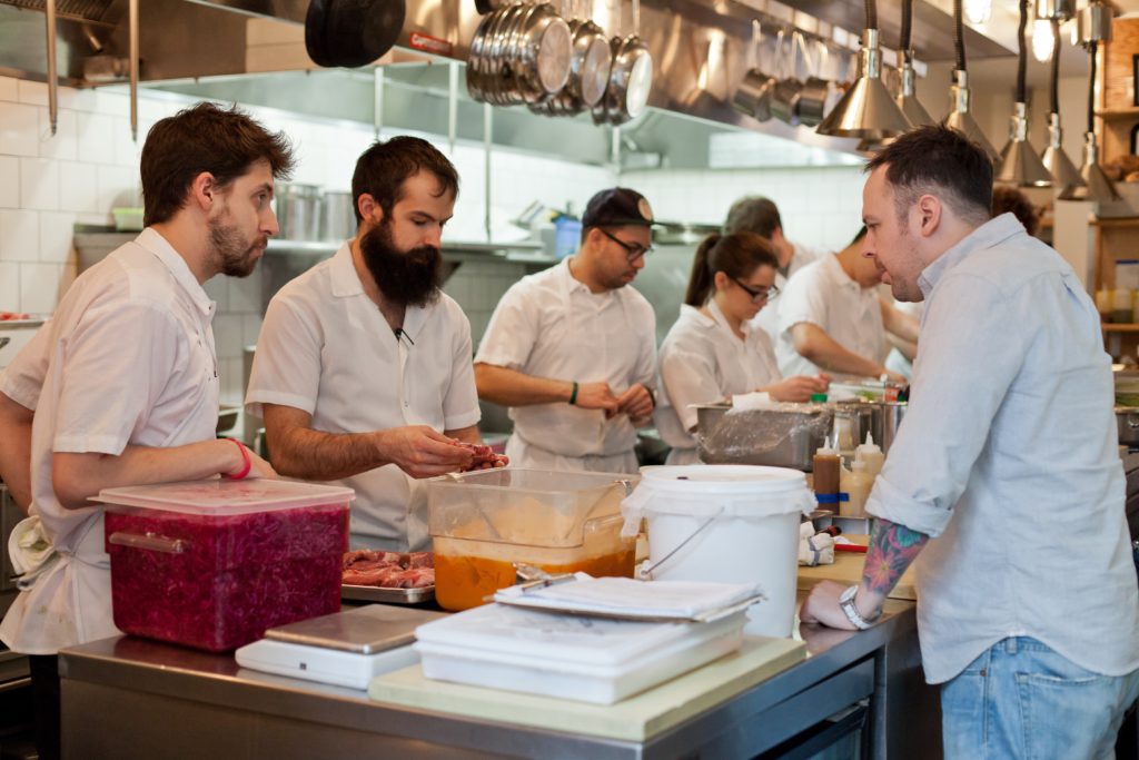 Chef Aaron Silverman in the kitchen with staff at Rose's Luxury