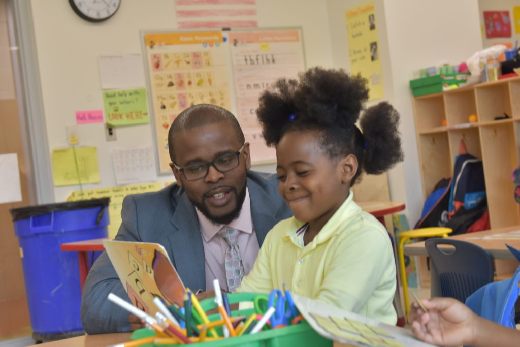 D.C. Public Schools Chancellor Antwan Wilson talks to a student during a school visit. 