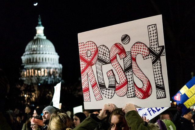 A protest sign calling for the reversal of President Trump’s travel ban on refugees and immigrants from several Middle Eastern countries.