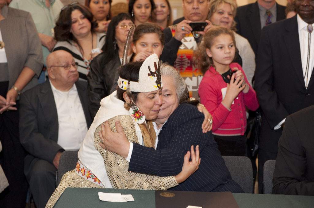 Natalie Proctor and Mervin Savoy, both of the Piscataway-Conoy Confederacy, embrace at a 2012 ceremony to celebrate Maryland's recognition of two tribes of Piscataway Indians.