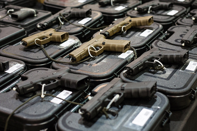 Rows of handguns lie on display cases at the Showmasters Gun Show on Sunday, March 25 in Richmond, Virginia. Handguns were the most popular firearm sold.