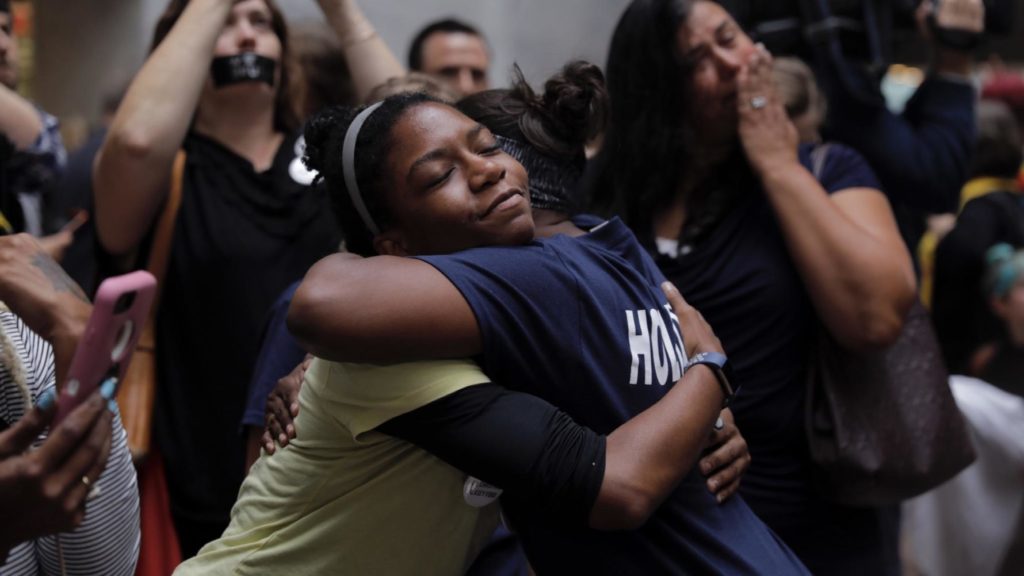 Women embrace at a protest outside the Kavanaugh hearing. 