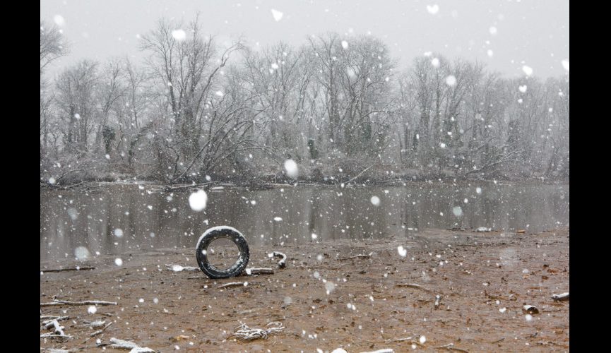 A tire on the Anacostia River in winter.