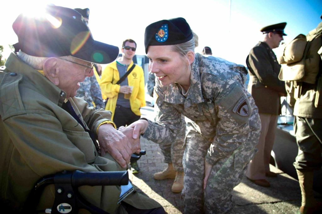 Victoria Chamberlin shakes the hand of a World War II paratrooper on June 6th, 2014 at a D-Day commemoration in Normandy, France.