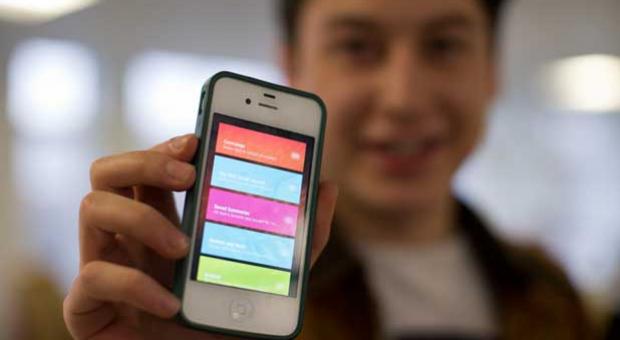 Nick d'Aloisio displays his mobile application Summly, as he poses for photographs after being interviewed by the Associated Press in London, Tuesday, March 26, 2013. 