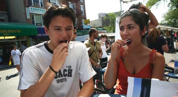 Genographic Project public participants swab the inside of their cheeks