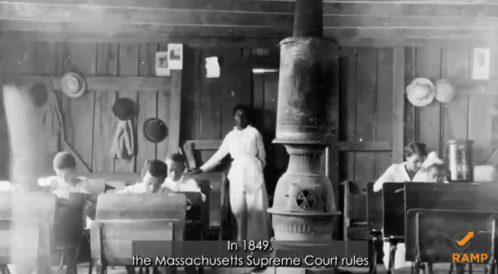 Black and white image of a Black woman standing in a kitchen. 