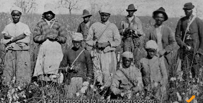 Group of Black individuals standing in a field.