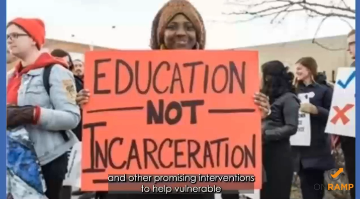 A woman holds a sign that says 