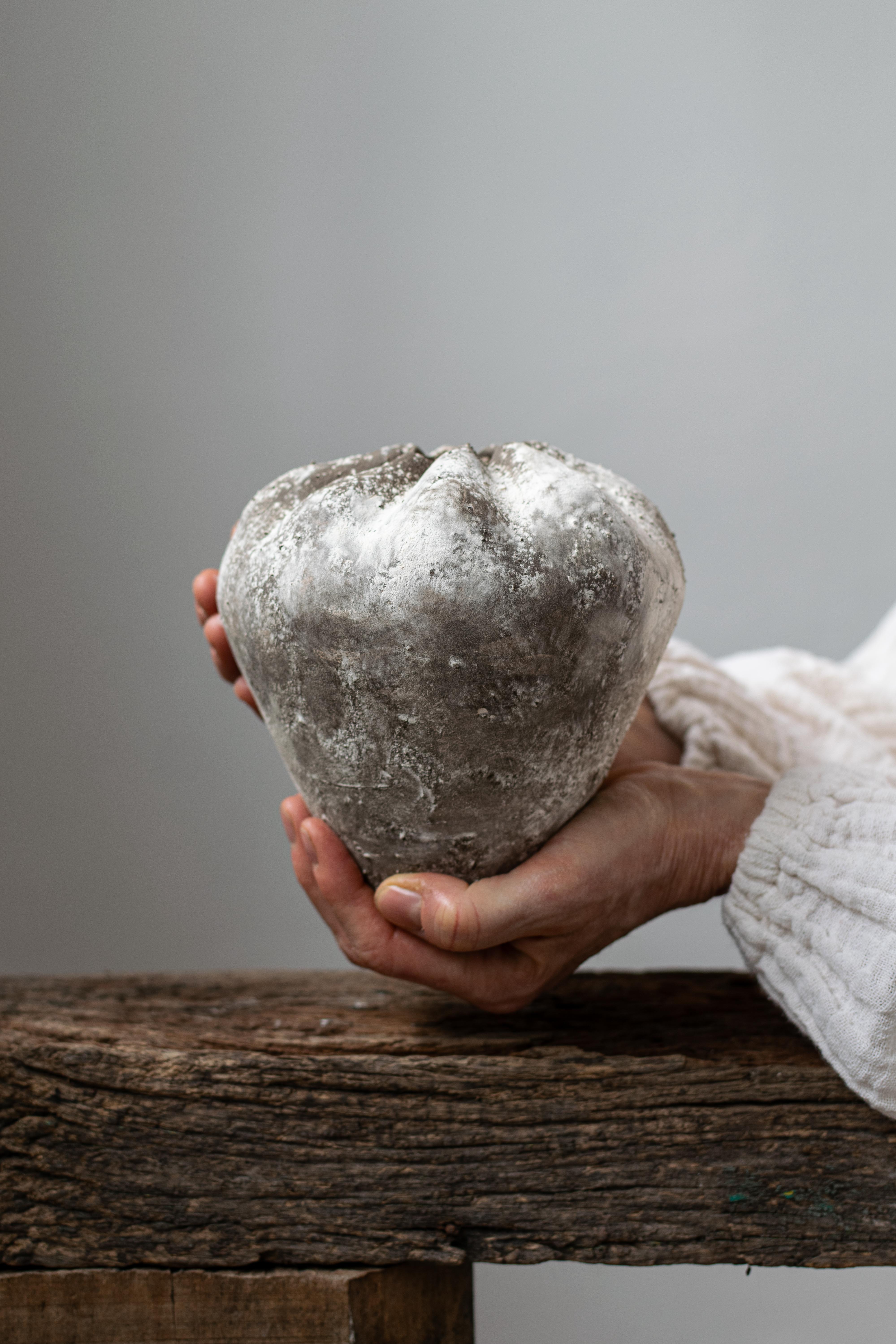 Handcrafted stoneware bottle in a warm bone color with a unique textured surface. Perfect for adding a touch of rustic elegance to your home decor