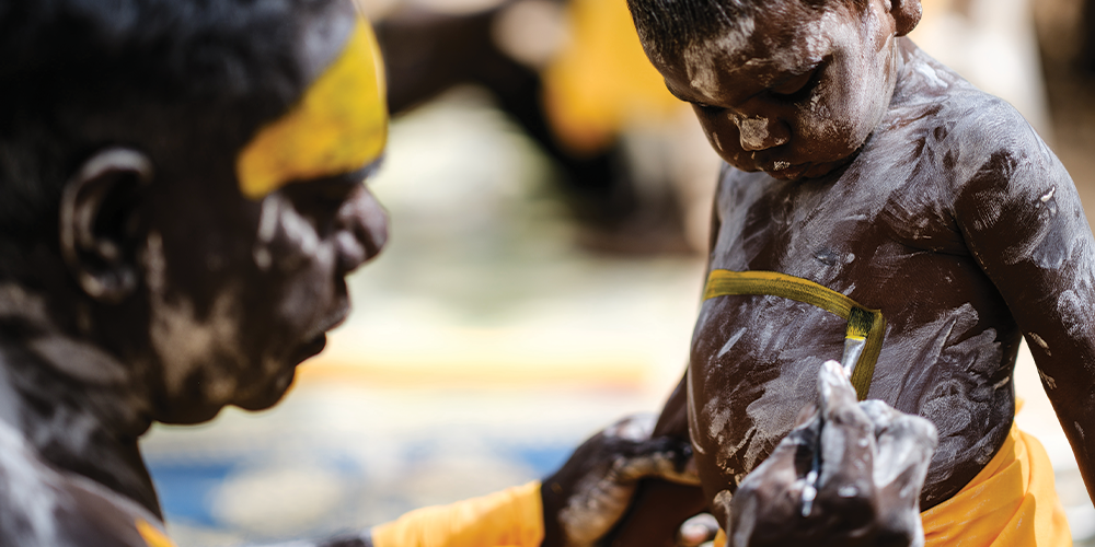 A young boy is painted ahead of ceremonial dancing.